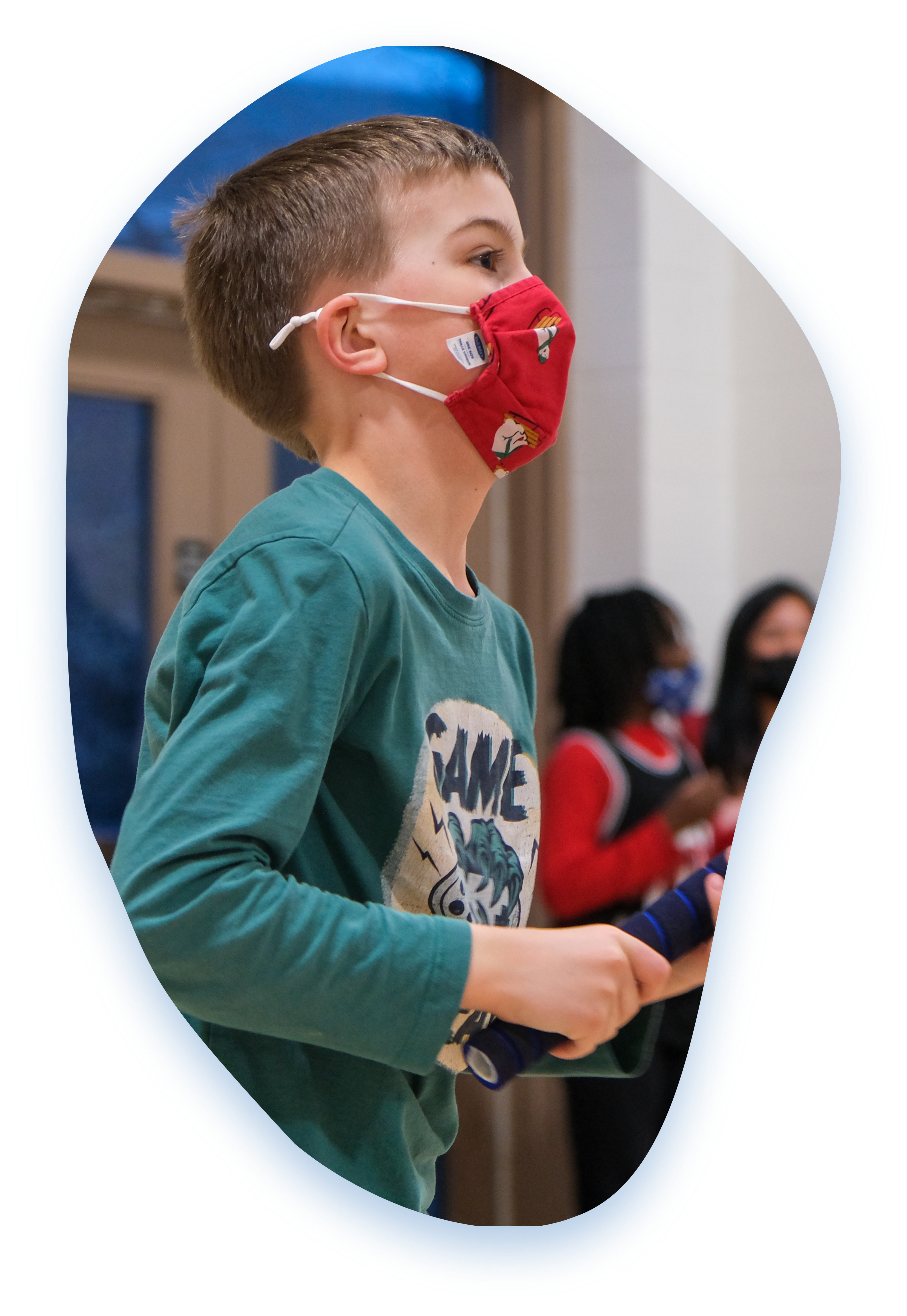 A Grandview Kids wears a mask and holds a sporting equipment, engaged in a sporting activity. 